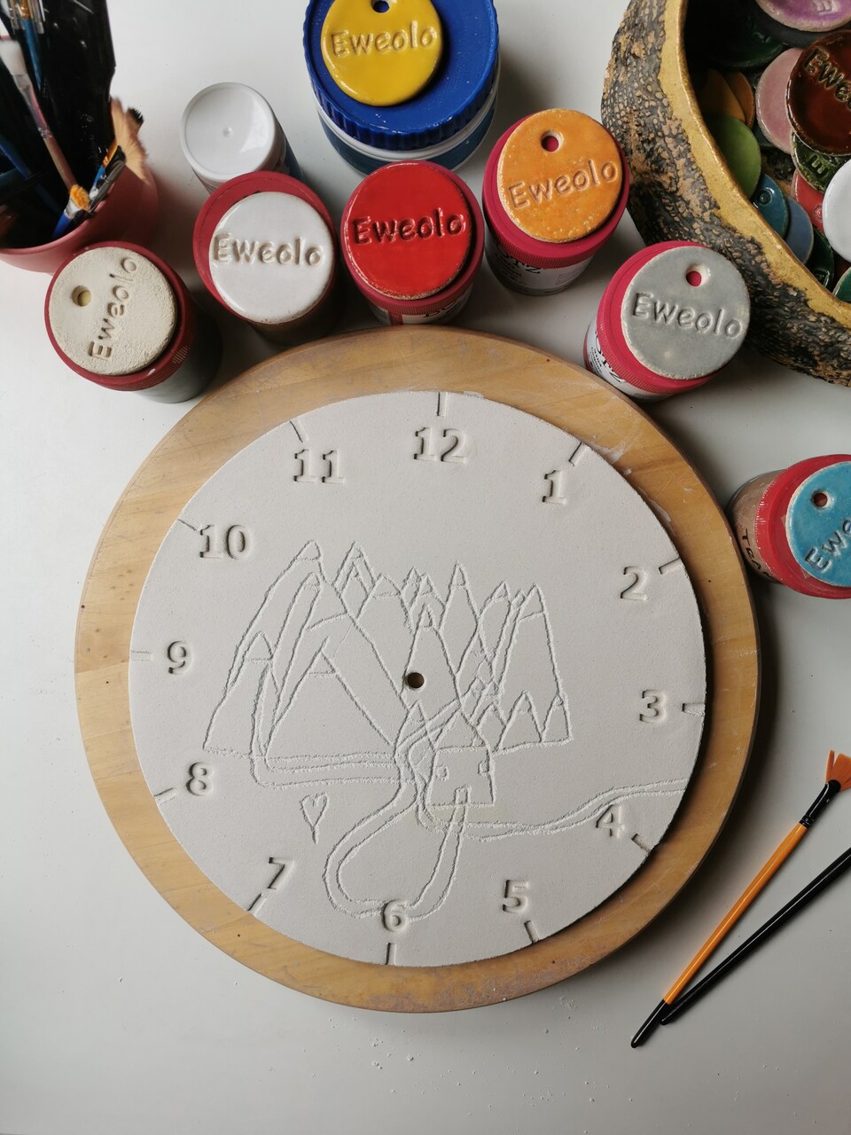 tarcza zegara z dziecięcym rysunkiem przed wypałem w piecu ceramicznym