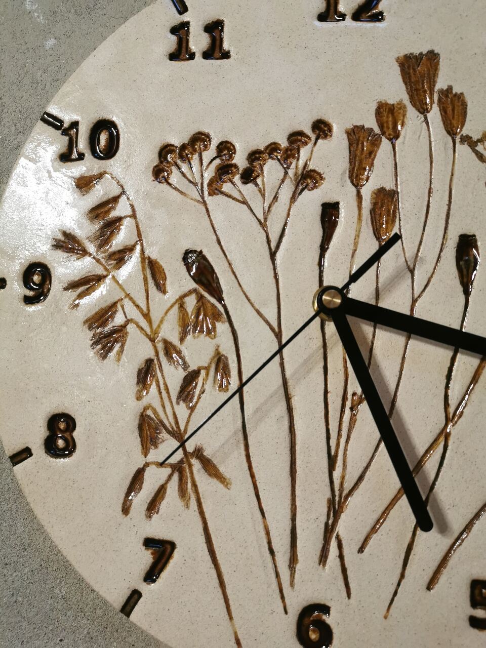Od lewej owies, mak, wrotycz, orlik odcisnięte polne kwiaty na zegarze z gliny